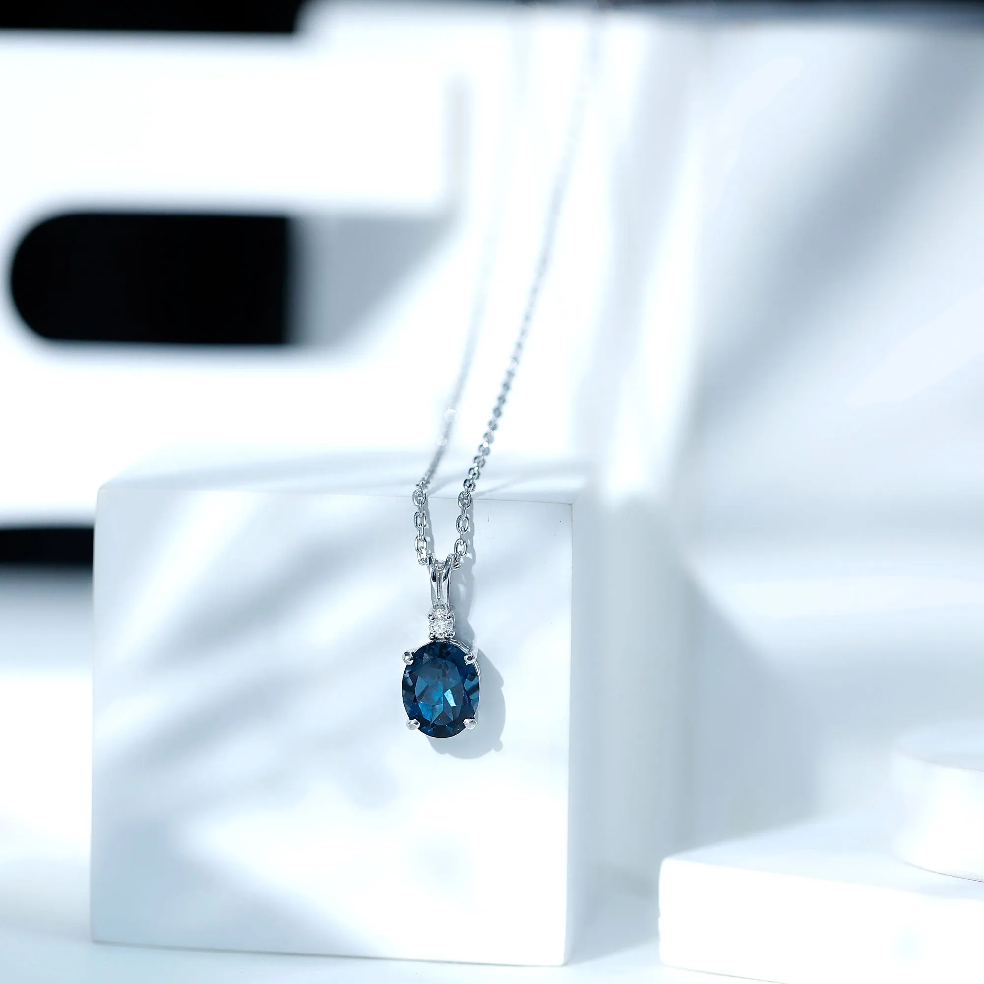 Oval London Blue Topaz Solitaire Pendant with Round Moissanite