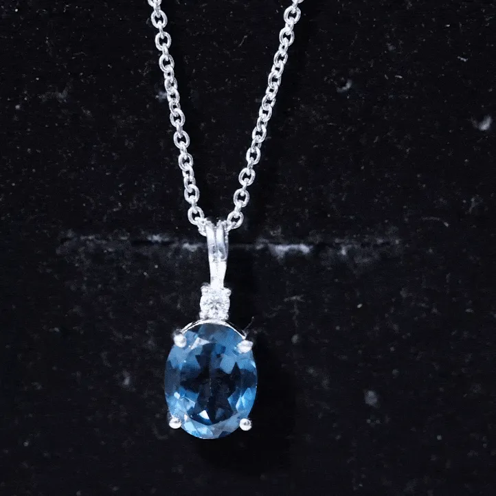 Oval London Blue Topaz Solitaire Pendant with Round Moissanite