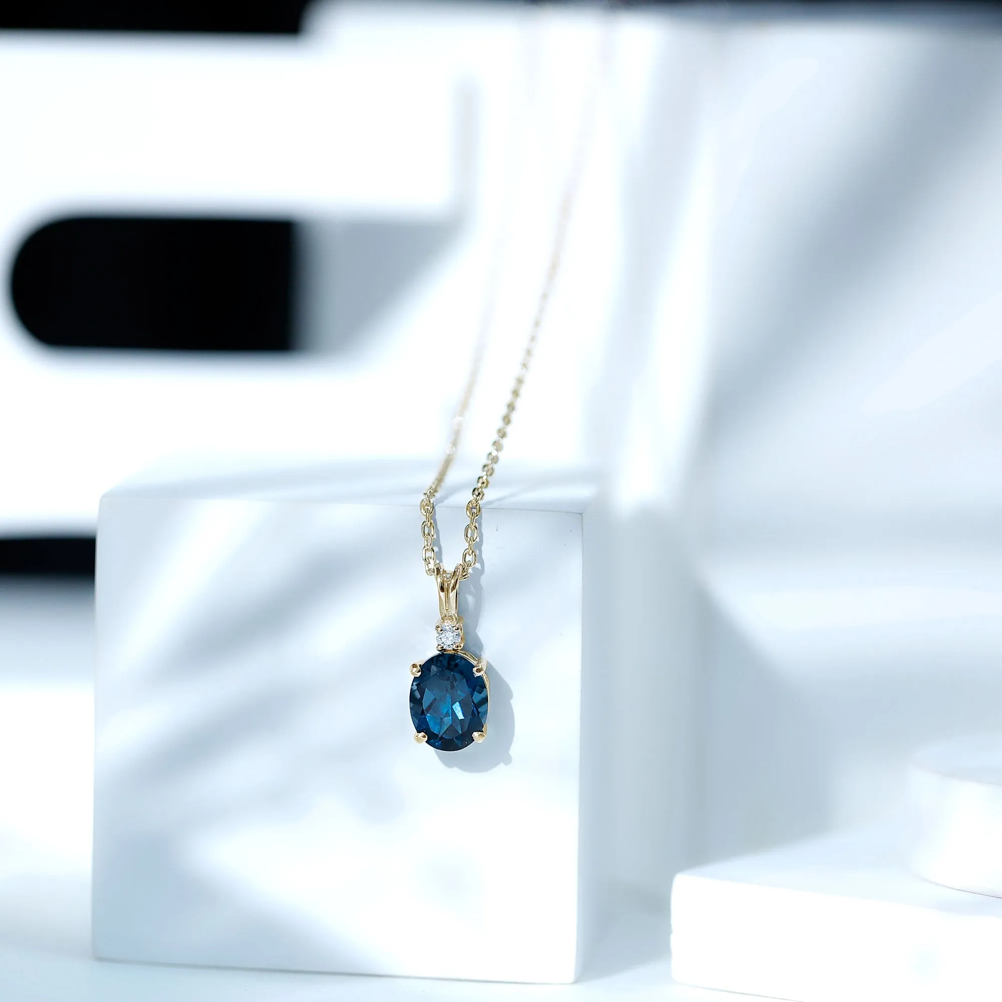 Oval London Blue Topaz Solitaire Pendant with Round Moissanite