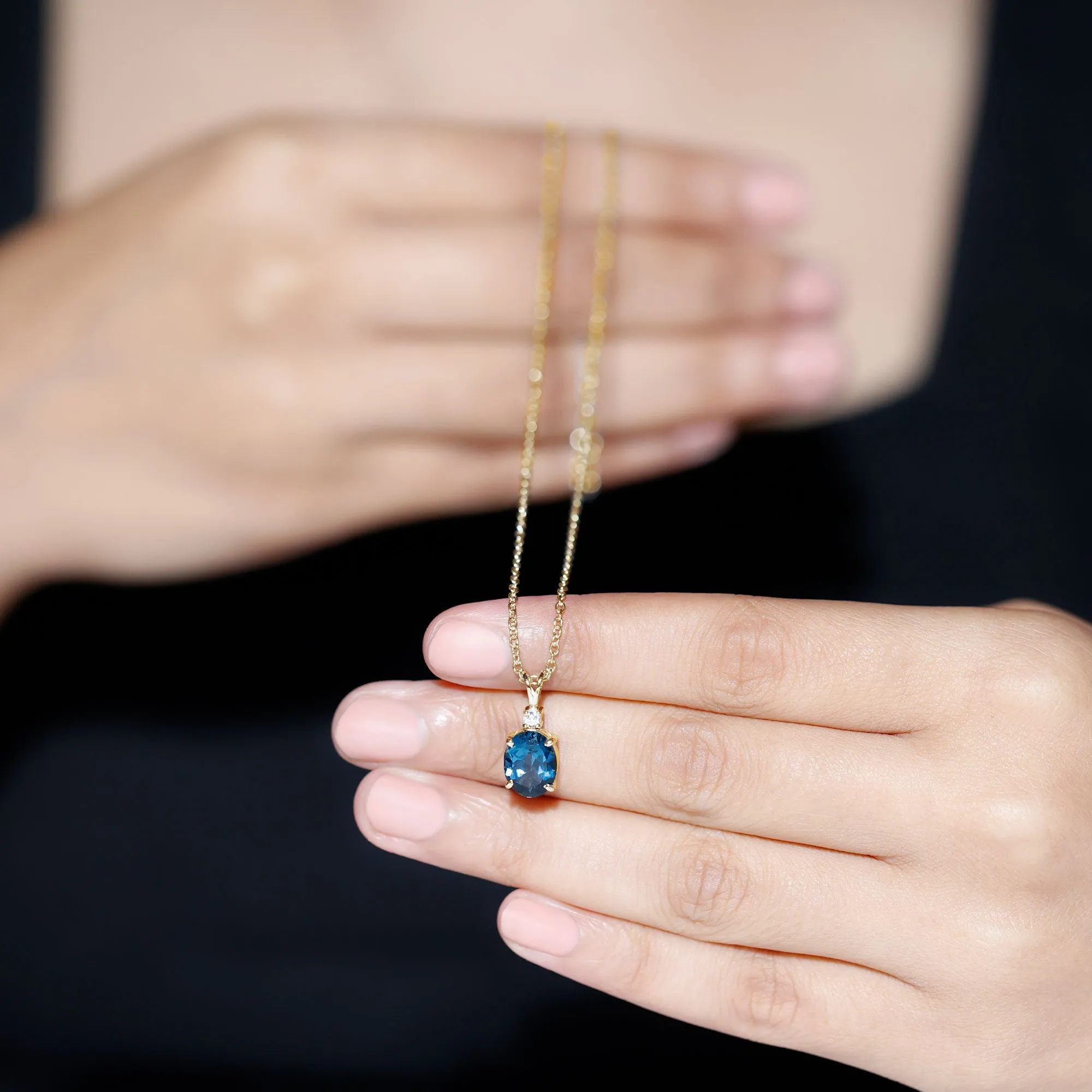 Oval London Blue Topaz Solitaire Pendant with Round Moissanite