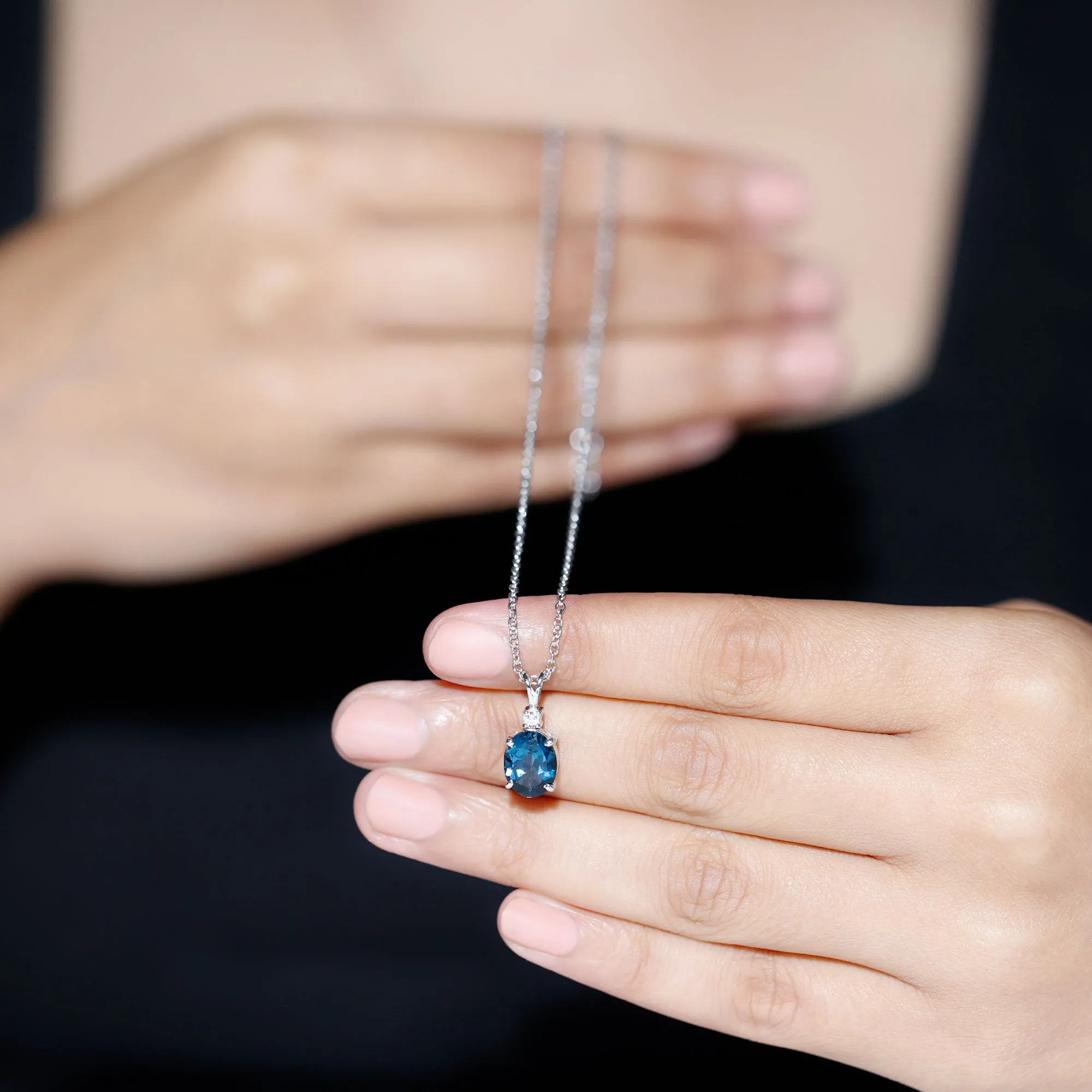 Oval London Blue Topaz Solitaire Pendant with Round Moissanite